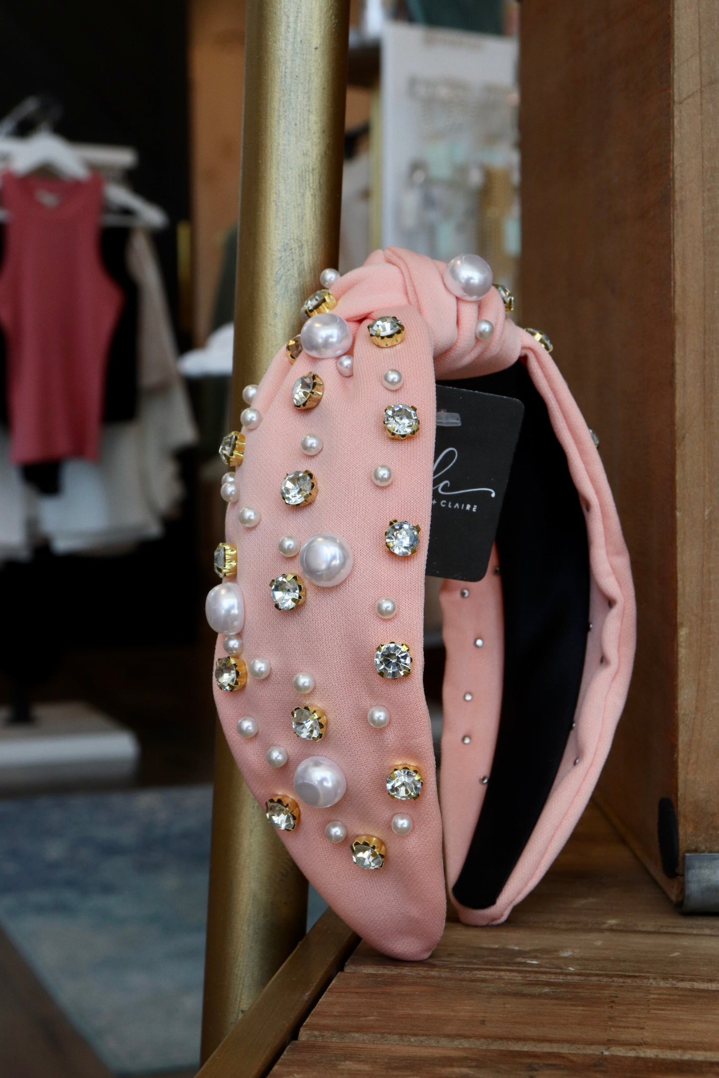 thick pink knotted headband with pearl and jewel detailing