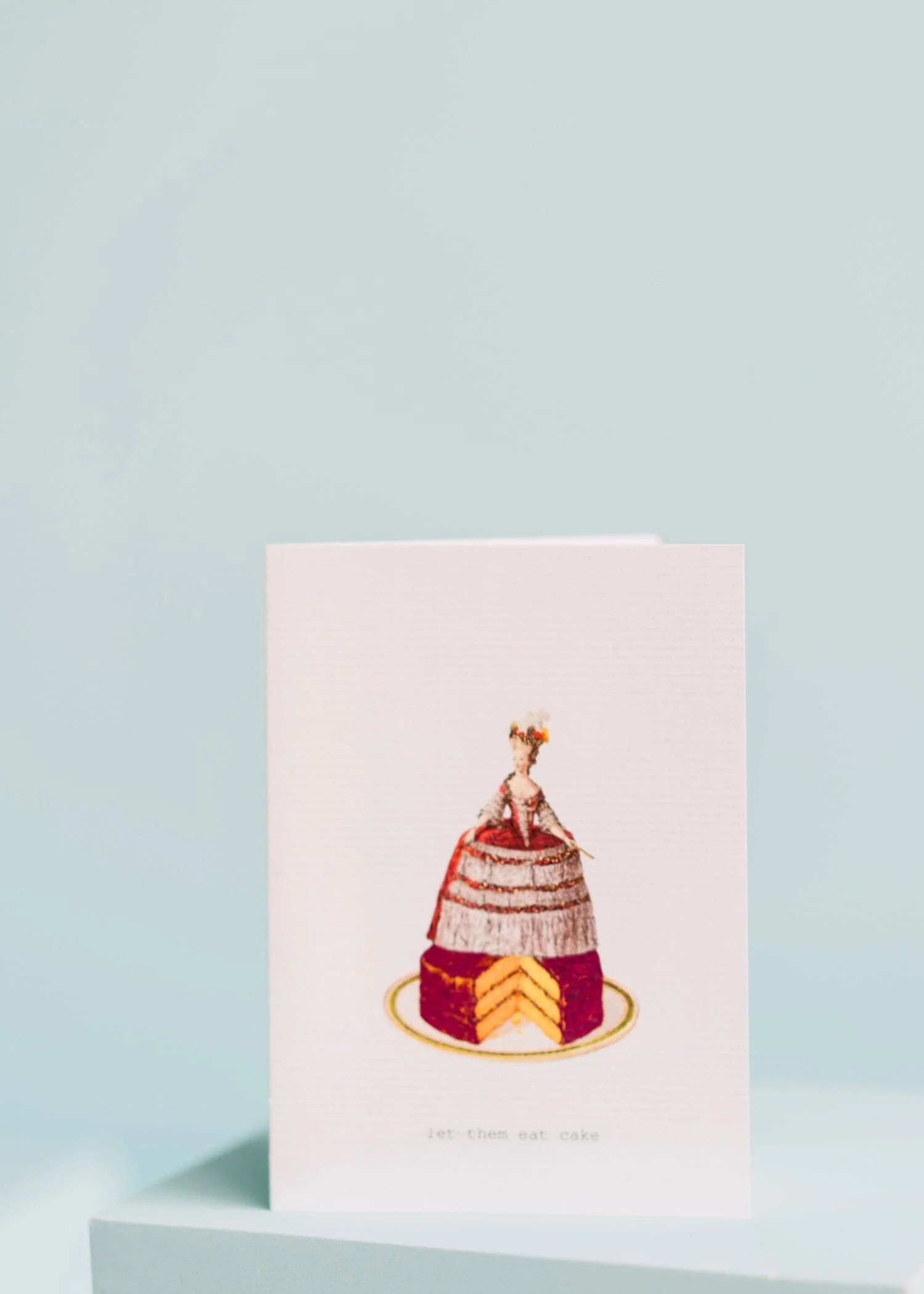 let them eat cake greeting card with illustration of a queen on top of cake