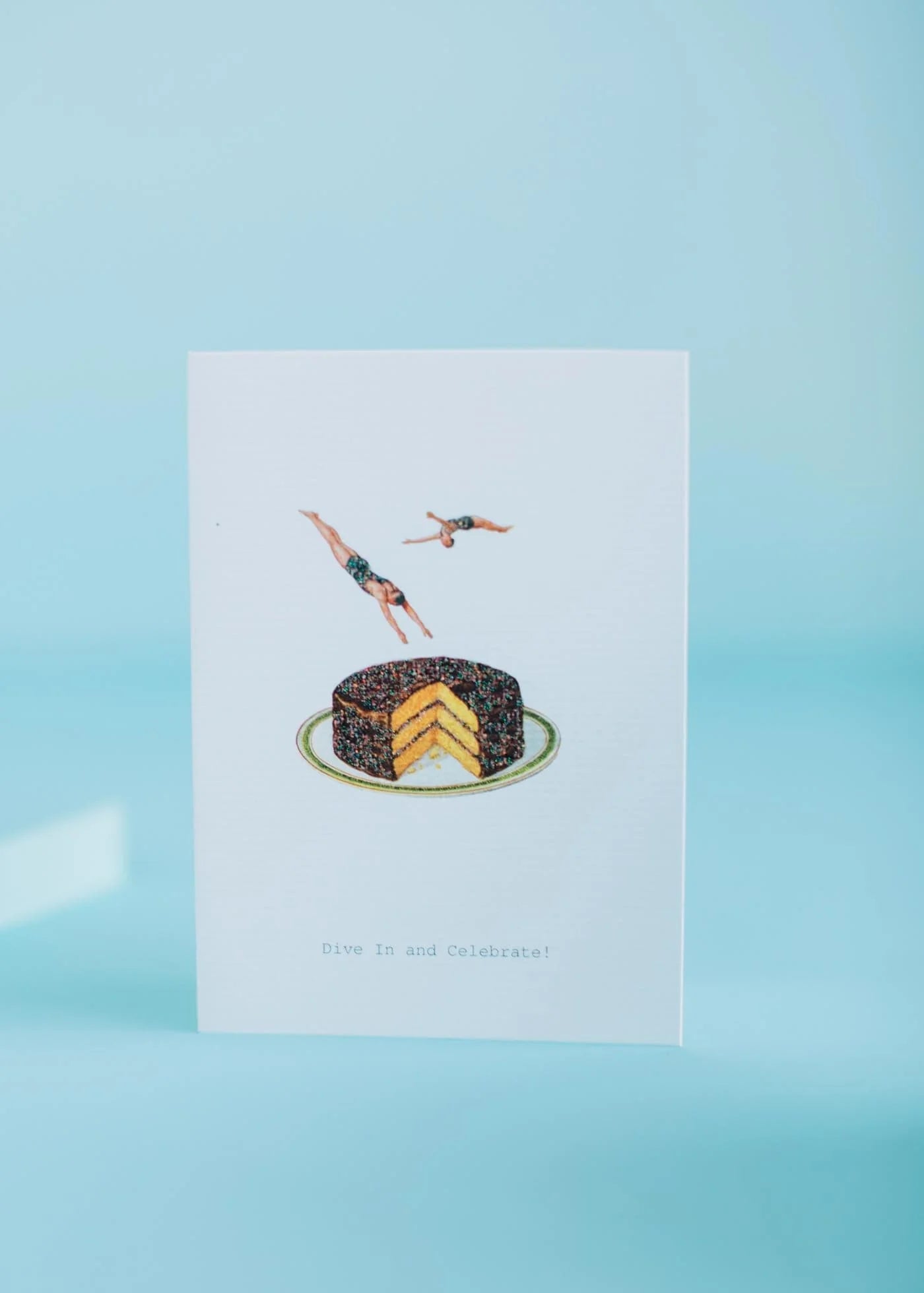 birthday card with illustration of two people diving into cake